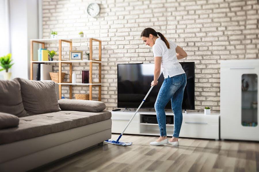 Professional cleaner performing a living room cleaning service